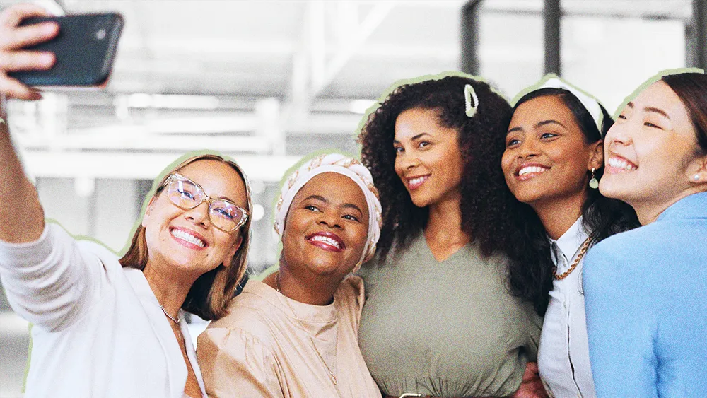 diverse group of smiling women posing for a selfie