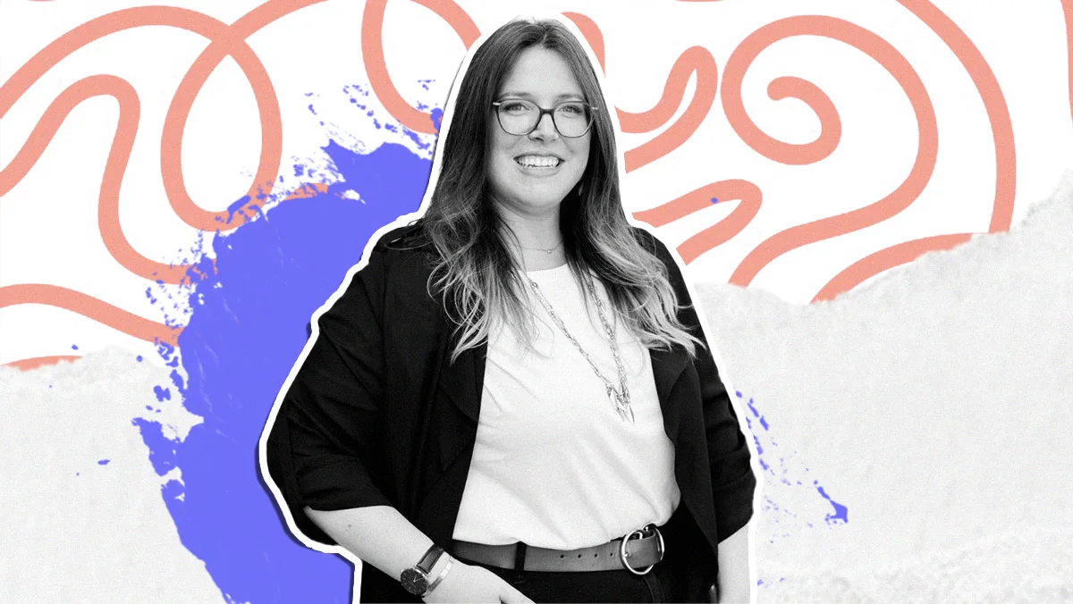 smiling woman with glasses in office casual attire