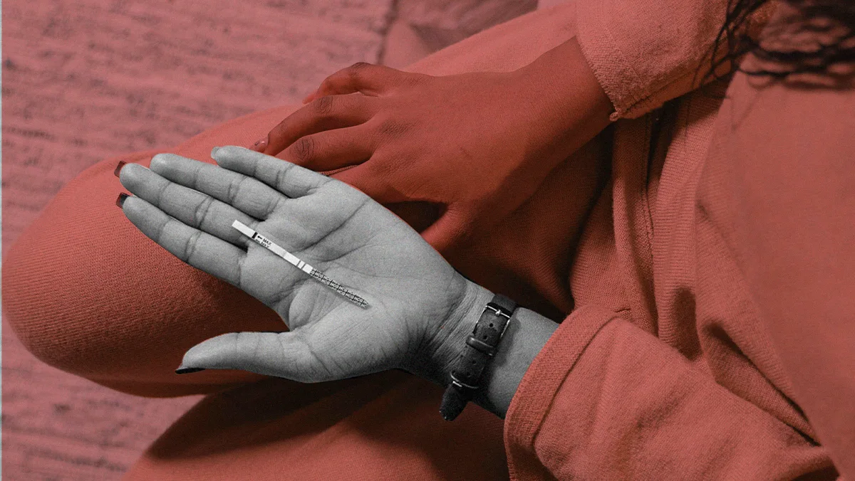 hand with stylish nails holding testing strip