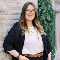 smiling woman with glasses in office casual attire