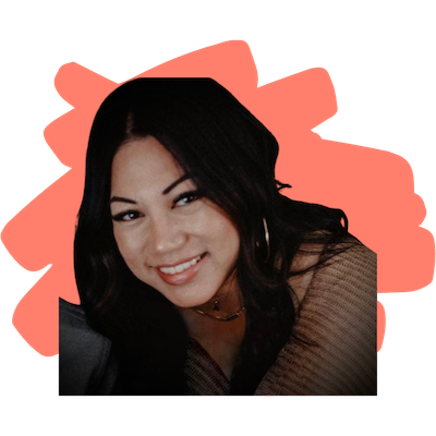 Smiling woman with long dark hair, wearing a brown top and gold hoop earrings, with an orange abstract shape background.