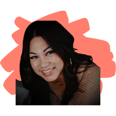 Smiling woman with long dark hair, wearing a brown top and gold hoop earrings, with an orange abstract shape background.