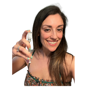 Smiling woman holding a syringe and a vaccine vial, preparing to fill the syringe.
