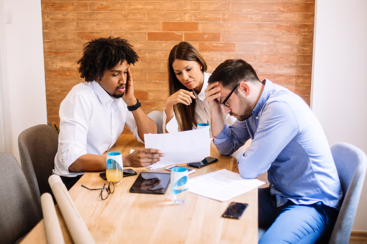 a very stressed looking man is shown resources and documentation in the workplace