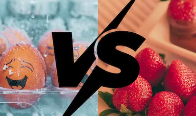 Frozen eggs with cartoon faces in a frost-covered carton versus fresh strawberries being dipped in chocolate sauce. Illustrating egg freezing vs. natural conception.