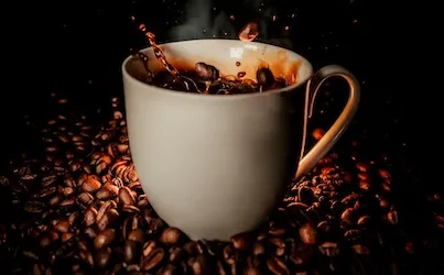 American Heart Association Statement: Coffee's fine. Energy drinks aren't. Up to 400mg of caffeine a day is safe for most hearts. The can is your fridge is another story.