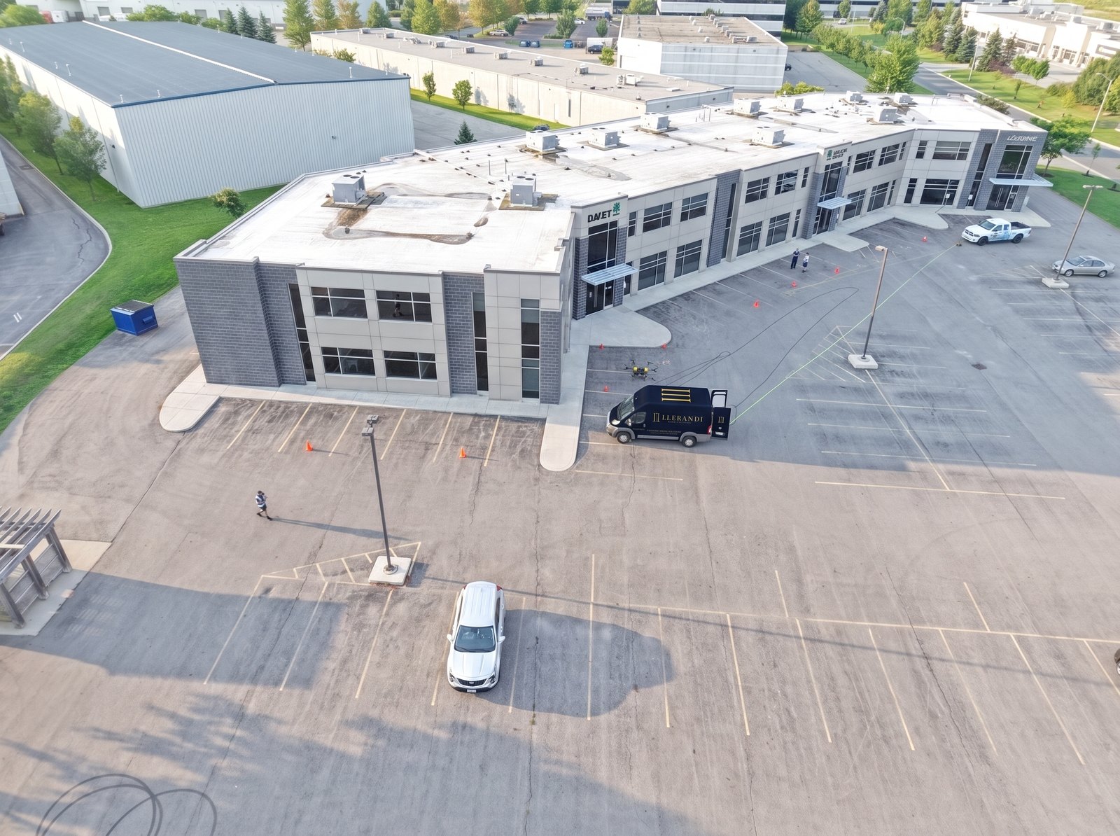 Llerandi Drone Solutions crew operating on a commercial site with the support vehicle and hose run in position