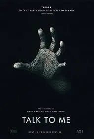 A pale hand with fingers spread reaching out from darkness, with text promoting the show 'Talk to Me' on ASE.