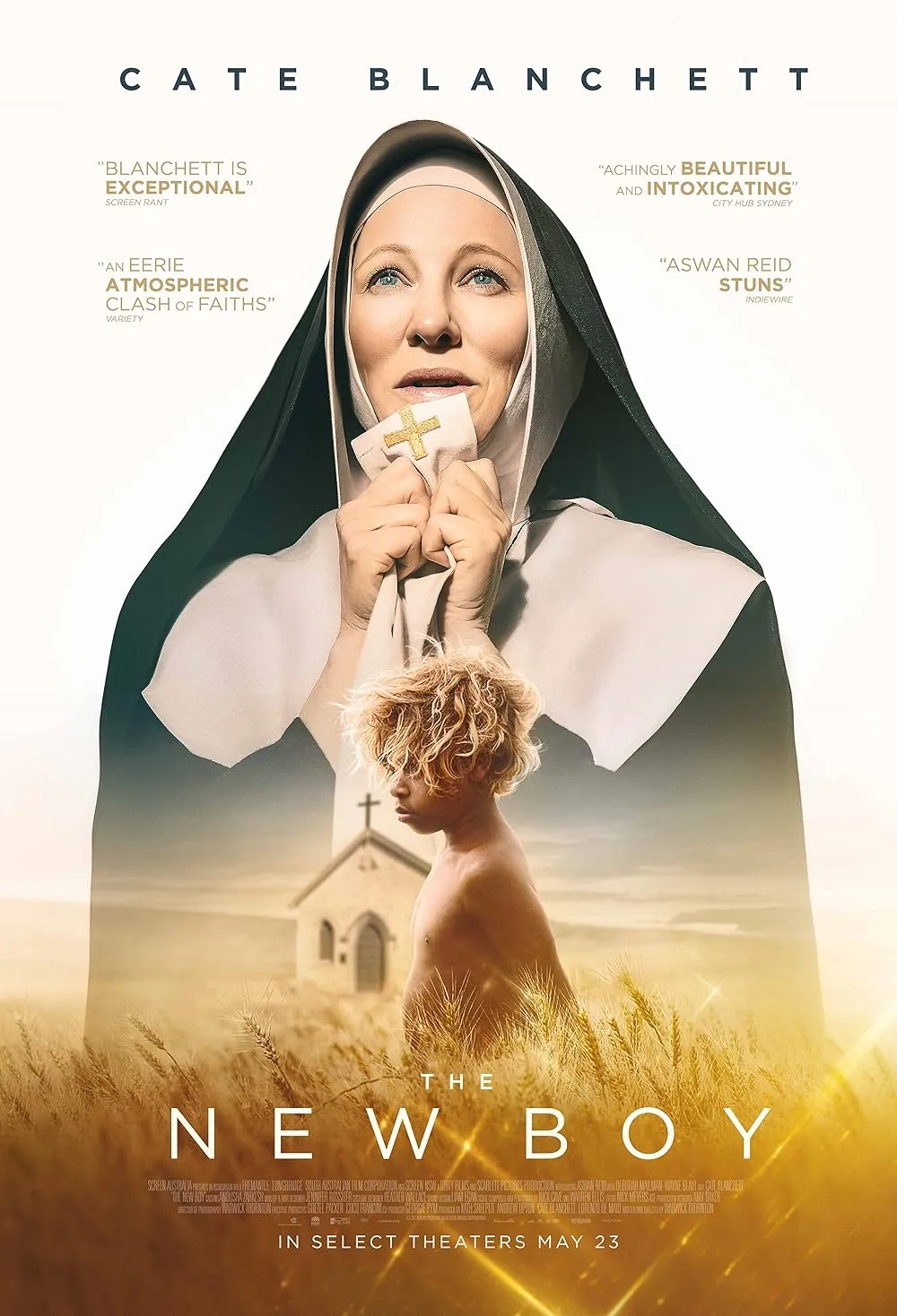 Movie poster of The New Boy featuring Cate Blanchett as a nun holding a cloth with a cross, with a young blonde boy standing shirtless in a wheat field in front of a church.