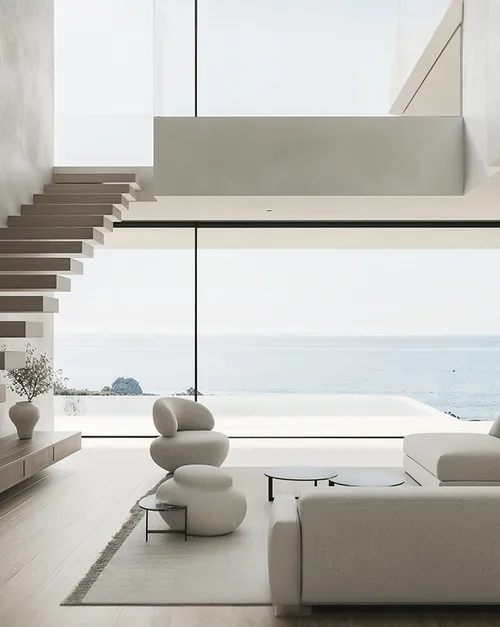 Minimalist living room with modern sculptural chairs, large sectional sofa, floating stairs, and floor-to-ceiling window overlooking the ocean.