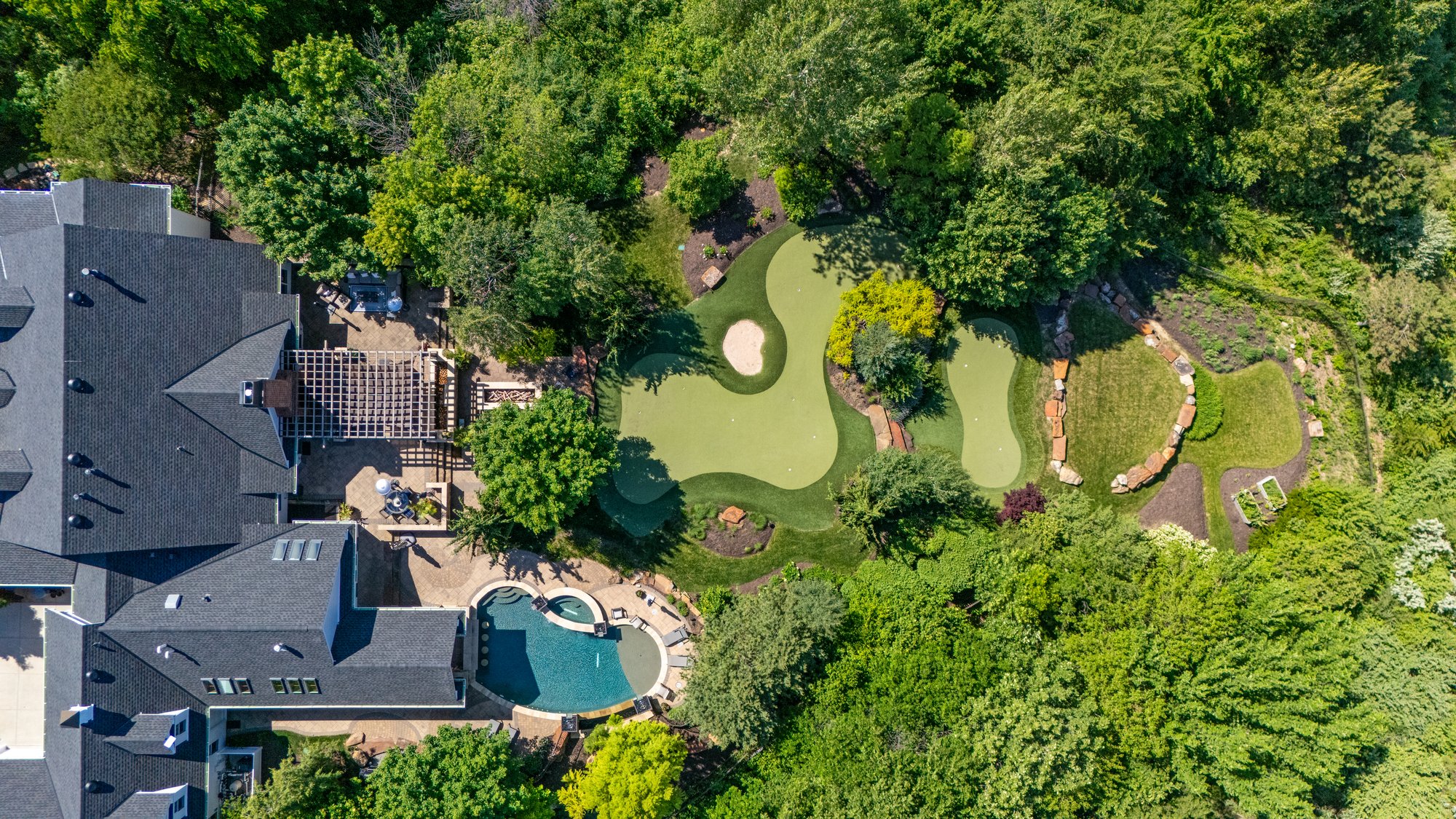 Aerial of wooded estate with golf green