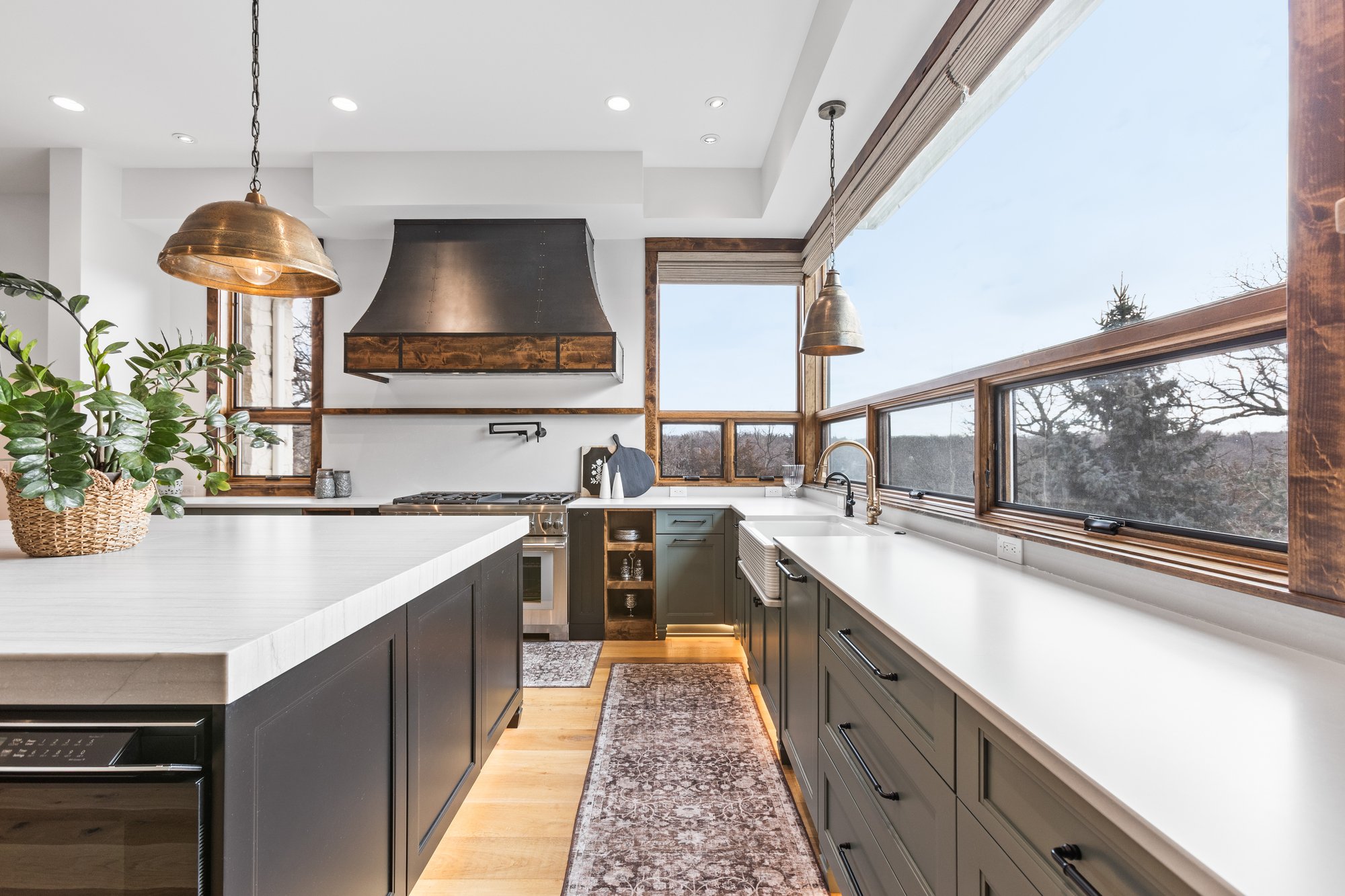 Bright kitchen with copper pendants and panoramic window