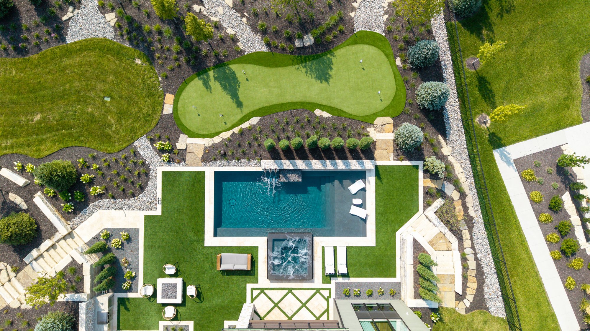 Aerial of backyard pool and putting green