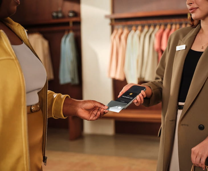 staff using tap to pay on her phone to accept payments