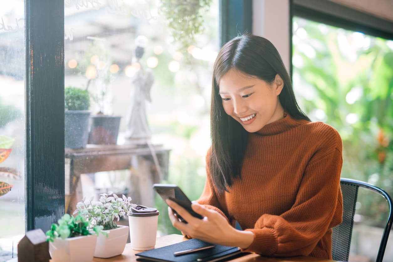 woman in a brown shirt using phone