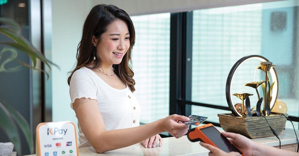 woman paying via credit card on kpay terminal pro
