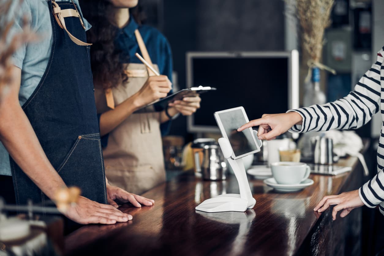 woman paying in a cafe