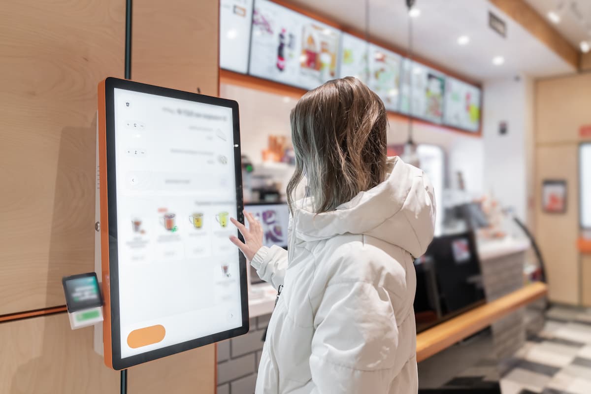 woman ordering on kiosk