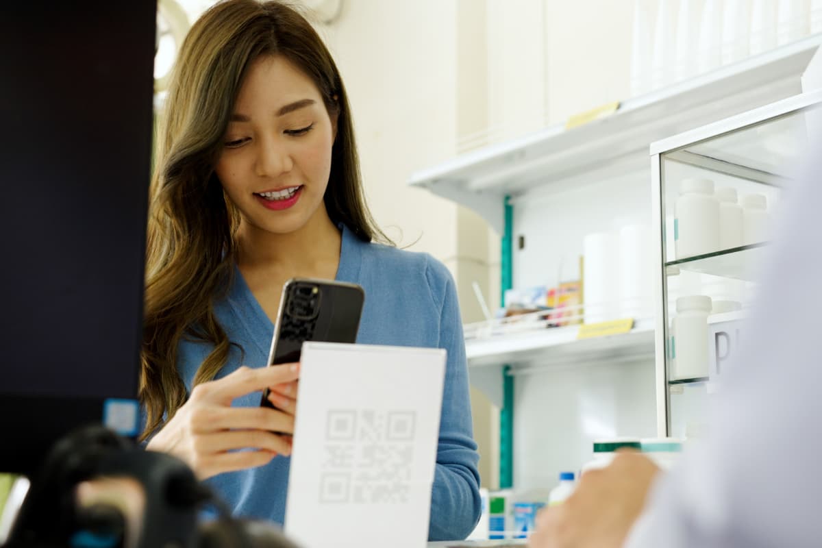 woman scanning qr code to make payment