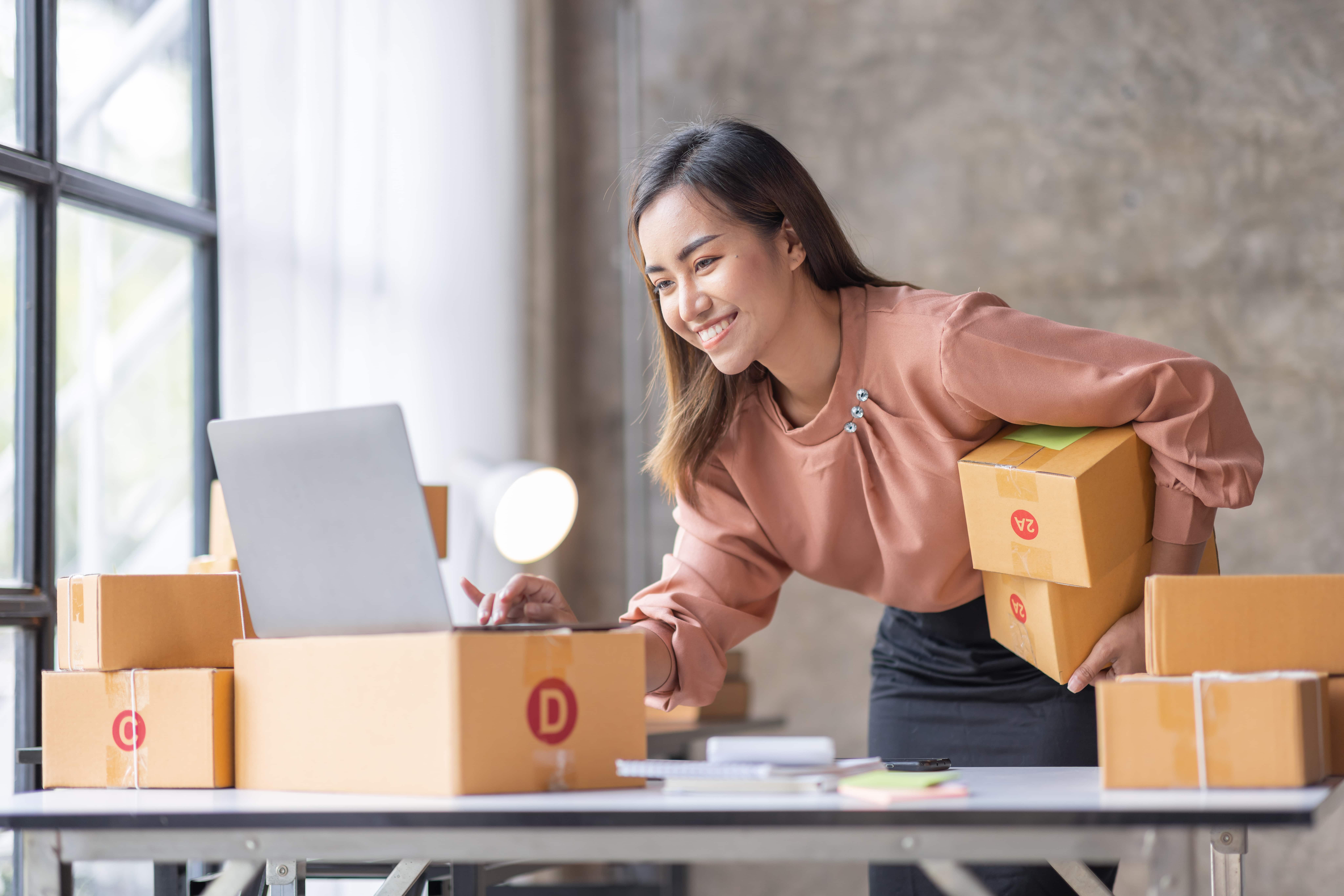 female business owner packing parcel