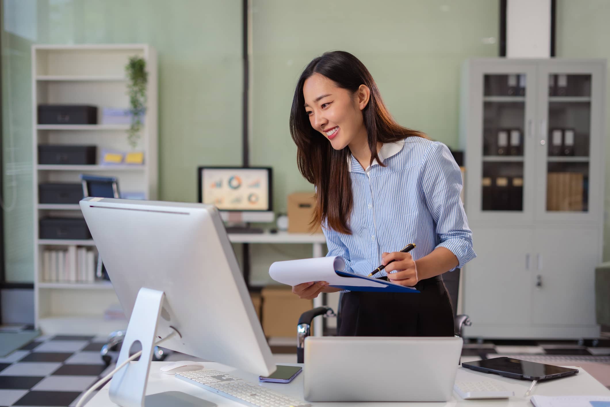 woman looking at laptop for media buying with virtual payment card
