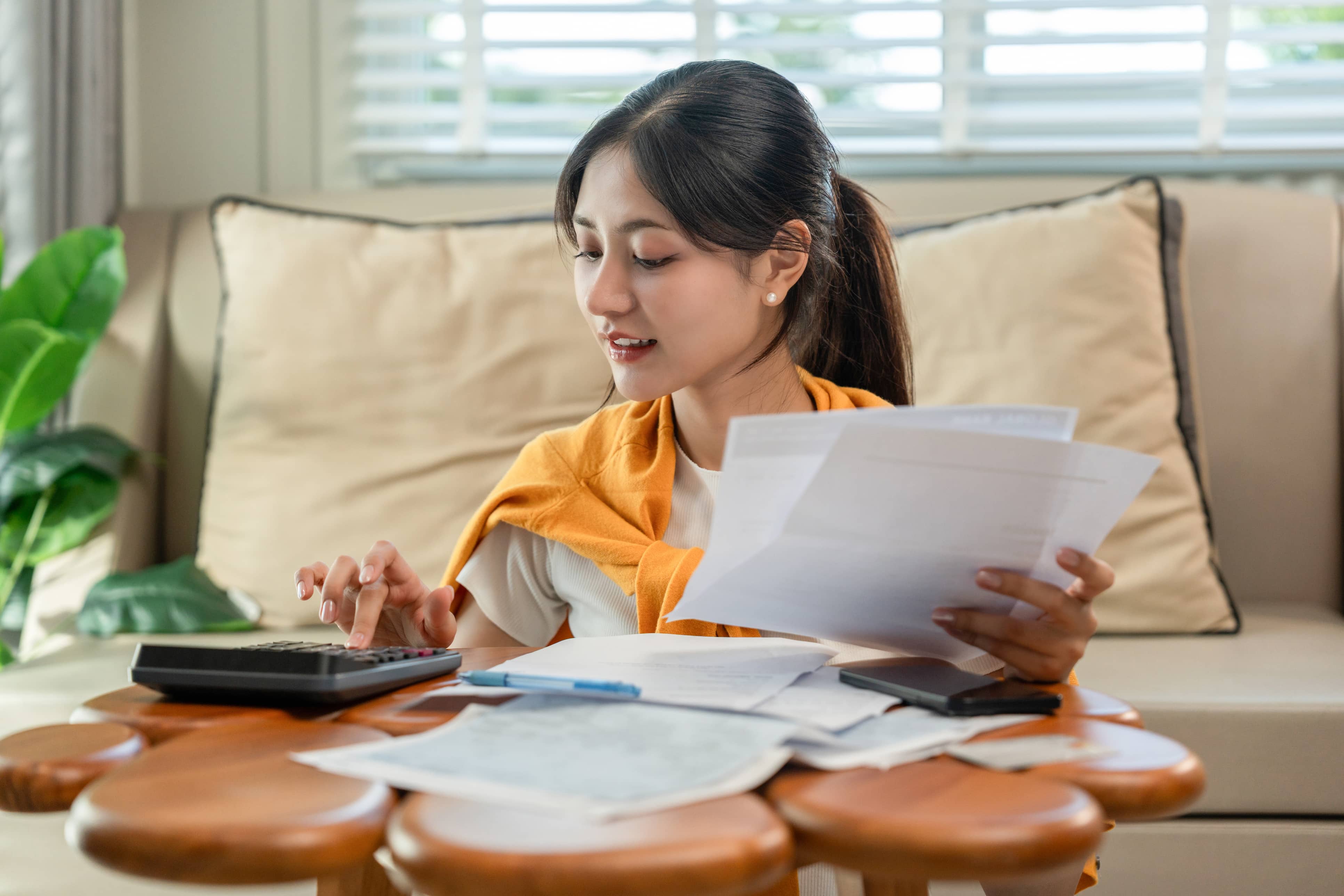 asian woman settling business invoices with kpay