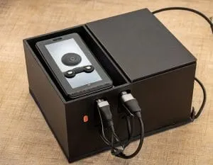 Image showing concept of an electronic device packaged in a repurposed box that becomes a charging station
