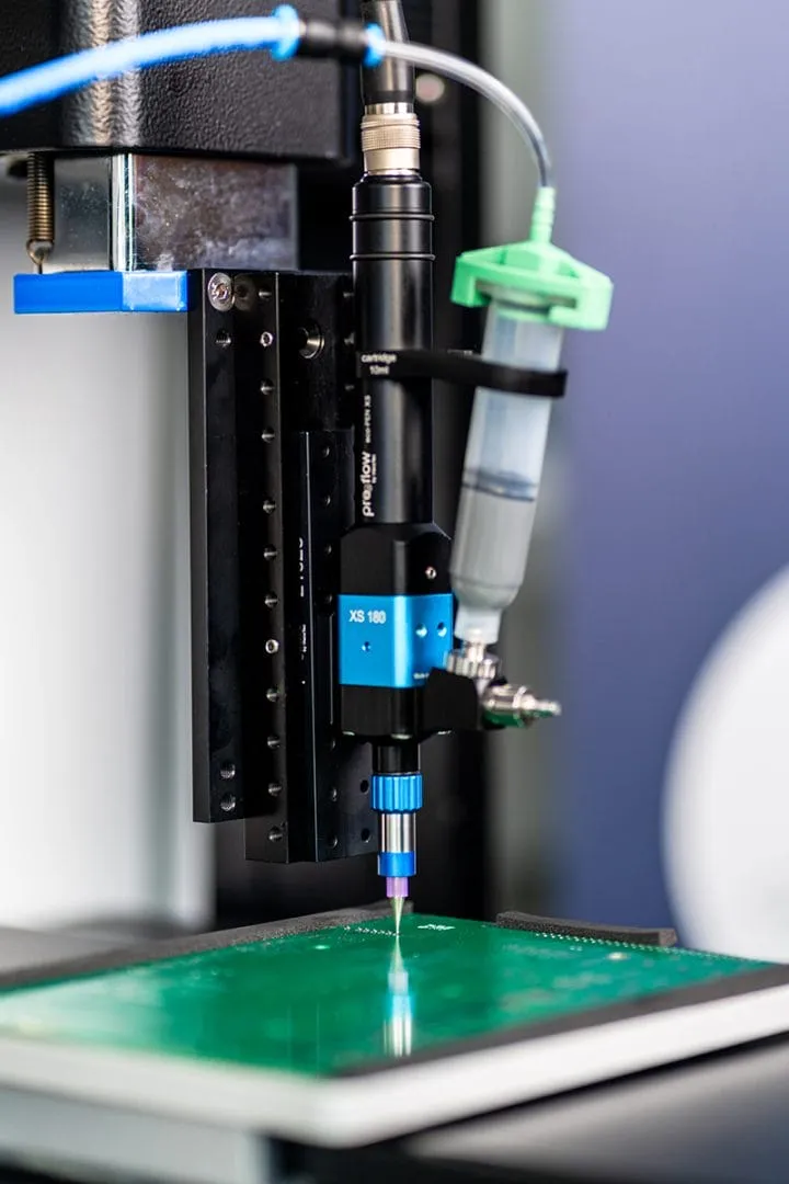 Image courtesy of ViscoTec showing the eco-PEN XS volumetric dispenser used with a circuit board application.