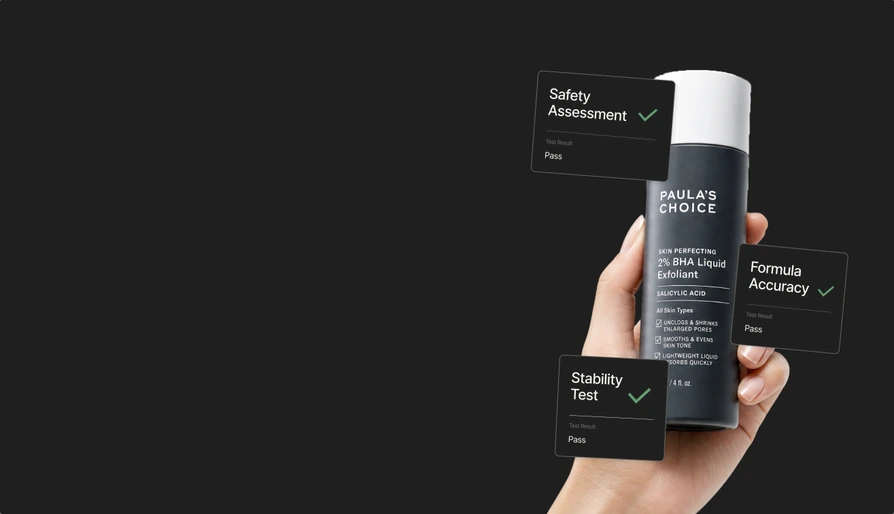 Hand holding a Paula's Choice BHA exfoliant with safety, formula and stability test cards