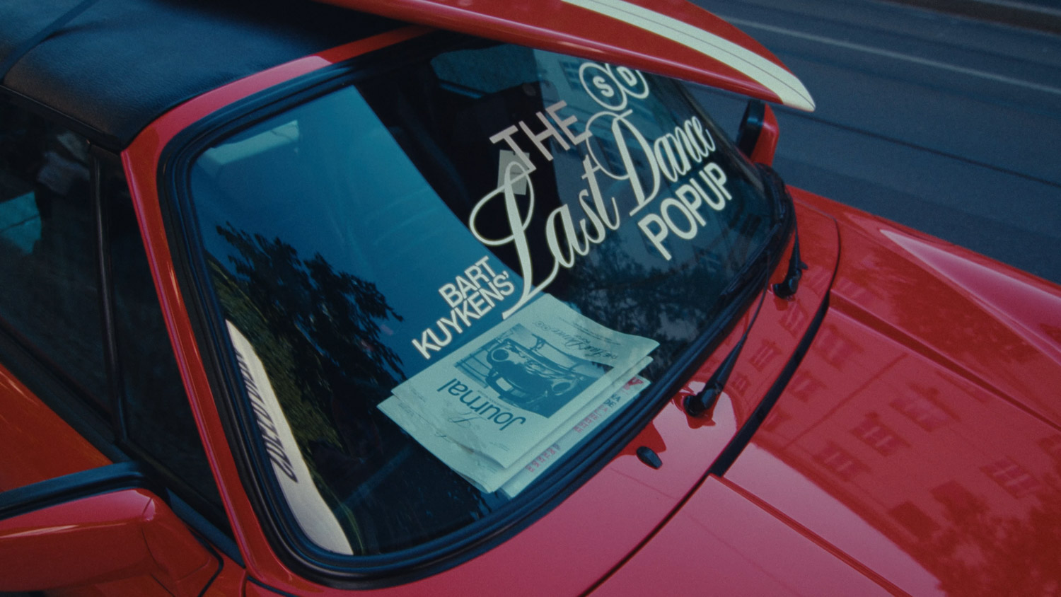 The Last Dance Pop Up lettering on the windscreen of a red car
