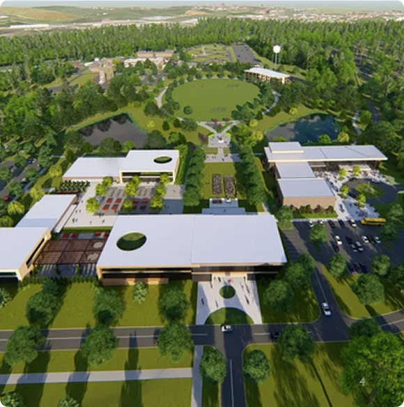 Aerial view of a large modern campus with multiple white-roofed buildings, central green lawn, surrounding trees, parking lots, and curved roads.