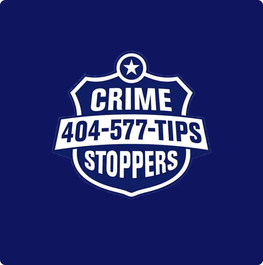 Crime Stoppers badge logo with phone number 404-577-TIPS on a dark blue background.