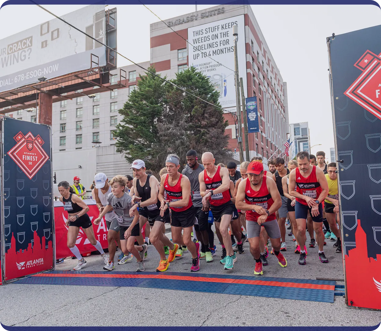 Runners at the starting line of Atlanta's Finest 5K race in an urban setting.