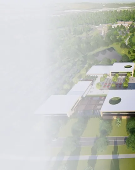 Aerial view of a modern campus with white-roofed buildings, surrounded by trees and greenery.