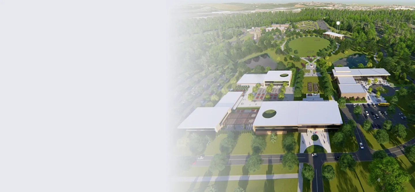 Aerial view of a modern campus with white-roofed buildings, green lawns, trees, and parking areas.