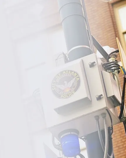 Mounted city surveillance or security device with a City of Atlanta Police emblem on a utility pole.