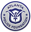 Seal of the Atlanta Police Foundation with blue text and logo on a gray circular background.