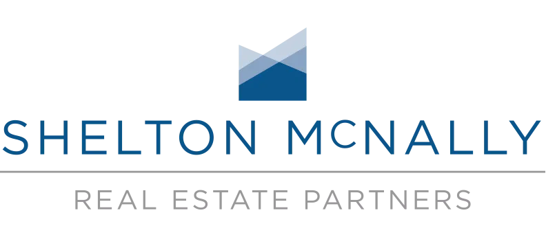 Shelton McNally logo with a stylized geometric mountain design above the company name and the words Real Estate Partners below a horizontal line.