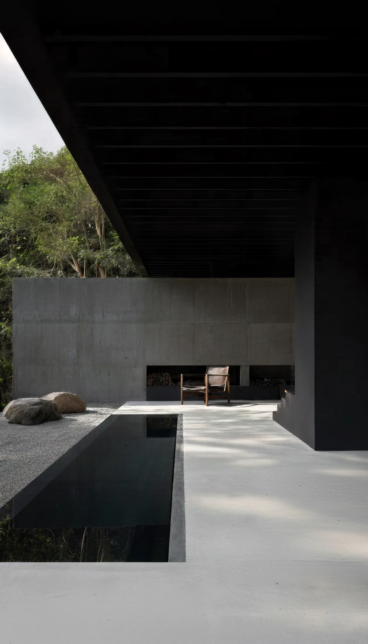 Timber-clad stable volumes of the Normandy equestrian estate set into the meadow landscape