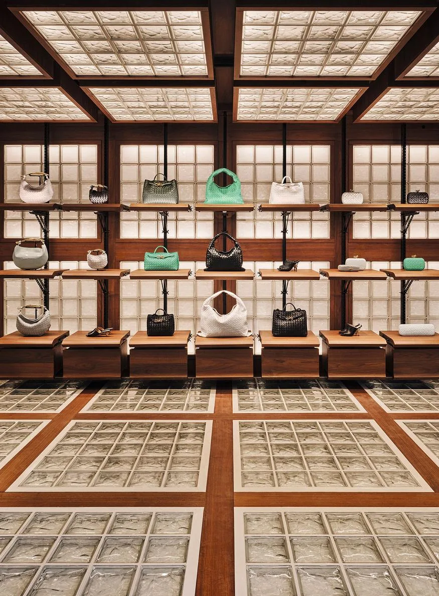 Display furniture and seating within the strict grid of the Bottega Veneta boutique