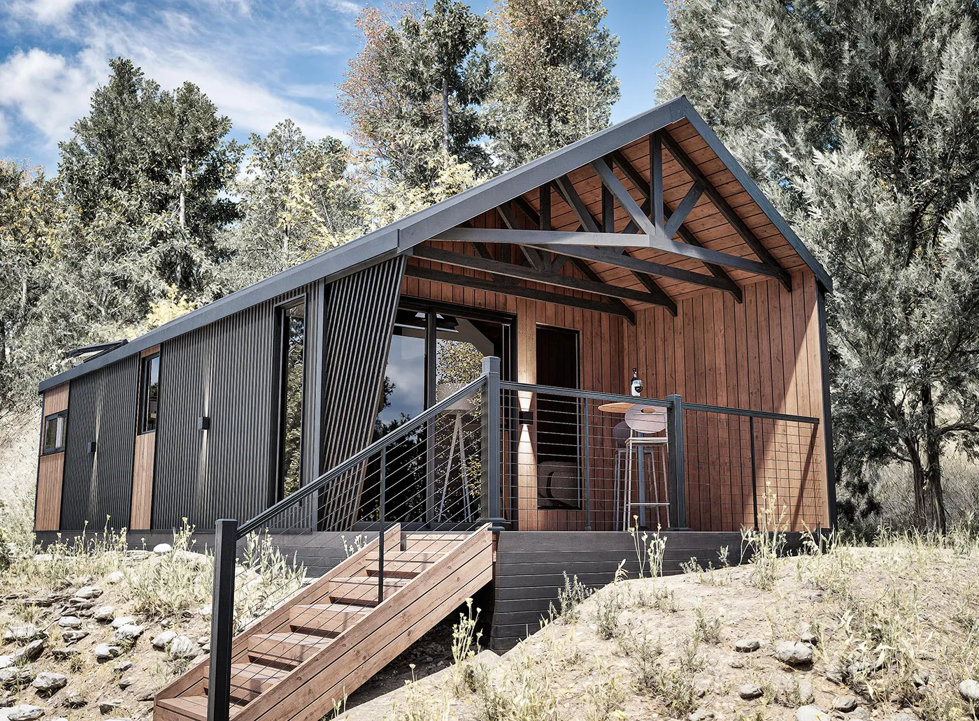 Cabin model Cliff with wood paneling and black accents surrounded by trees under a cloudy blue sky.