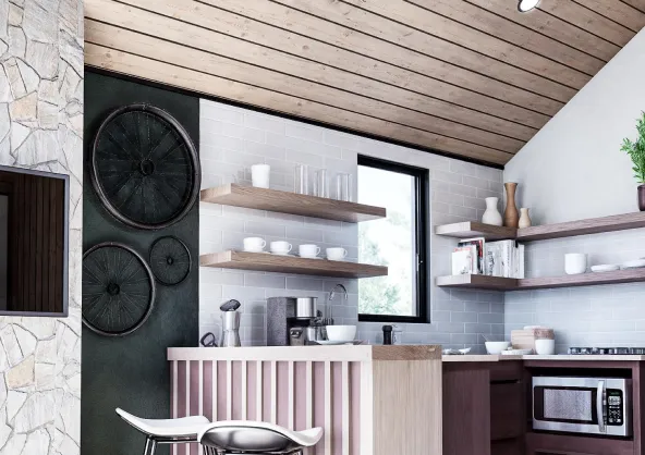 Modern kitchen with wooden ceiling, stone wall, bicycles mounted on dark wall, open shelves with cups and glasses, and a breakfast bar with a white stool.