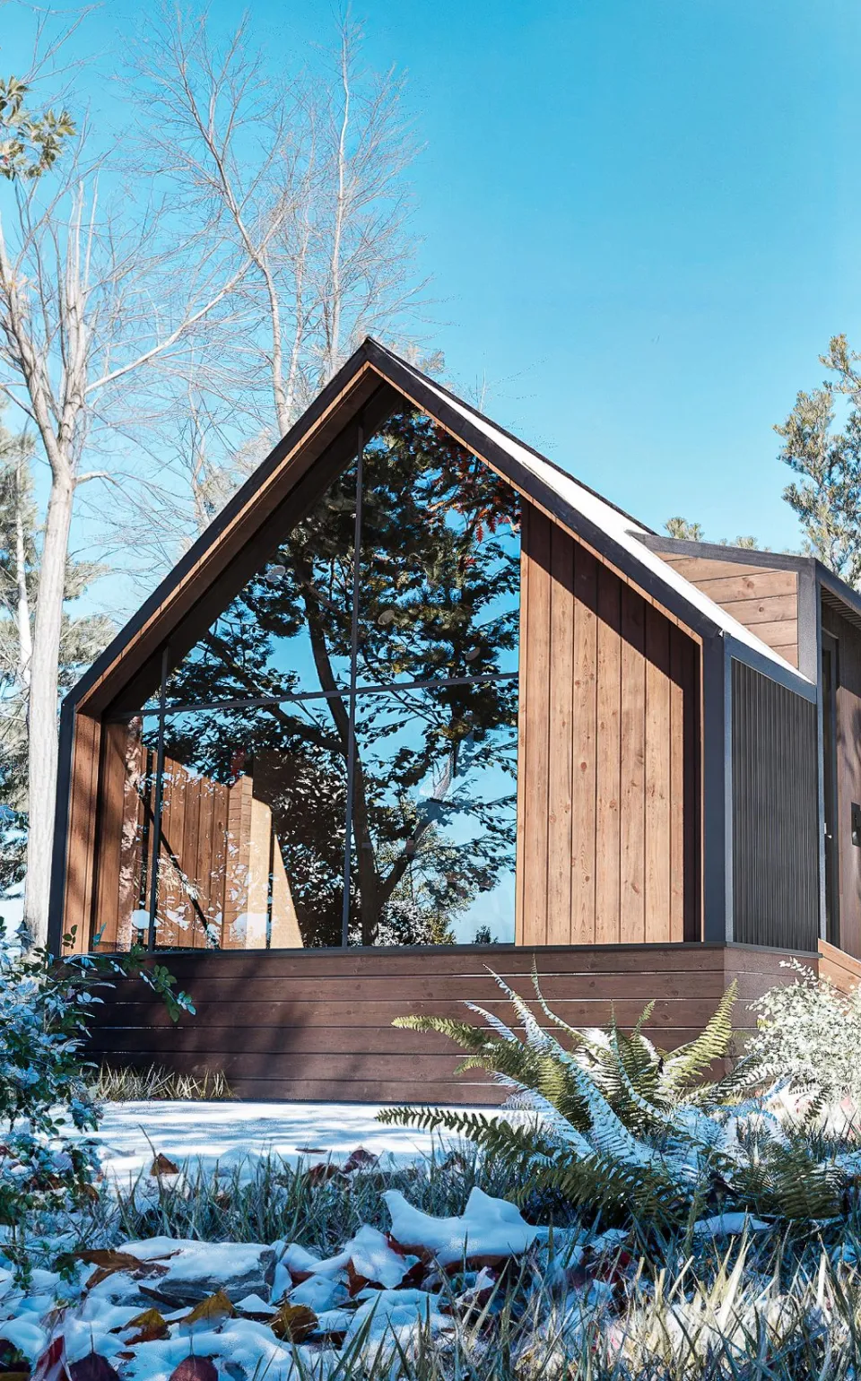 Modern wooden cabin with large glass windows surrounded by snowy forest vegetation.