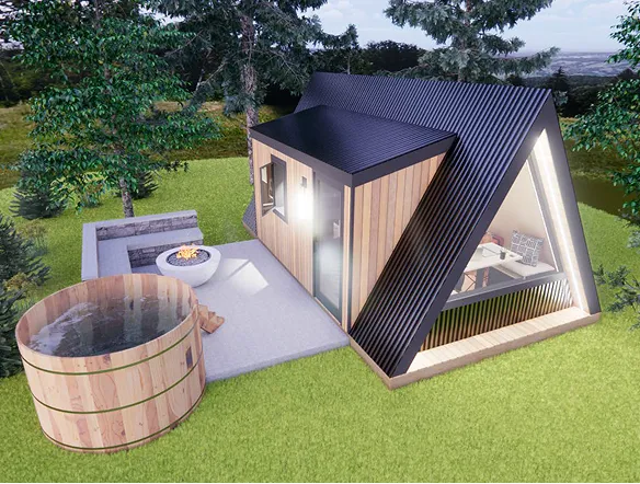 A modern A-frame tiny house with wood and black metal exterior, next to a fire pit and a round wooden hot tub, surrounded by grass and trees.