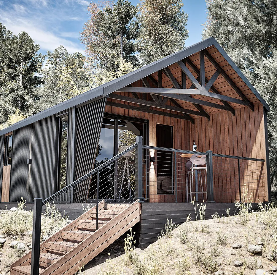 The cliff model cabin with a gabled roof and a wooden deck, featuring a small outdoor table, stools, and a staircase leading up from a dirt slope.