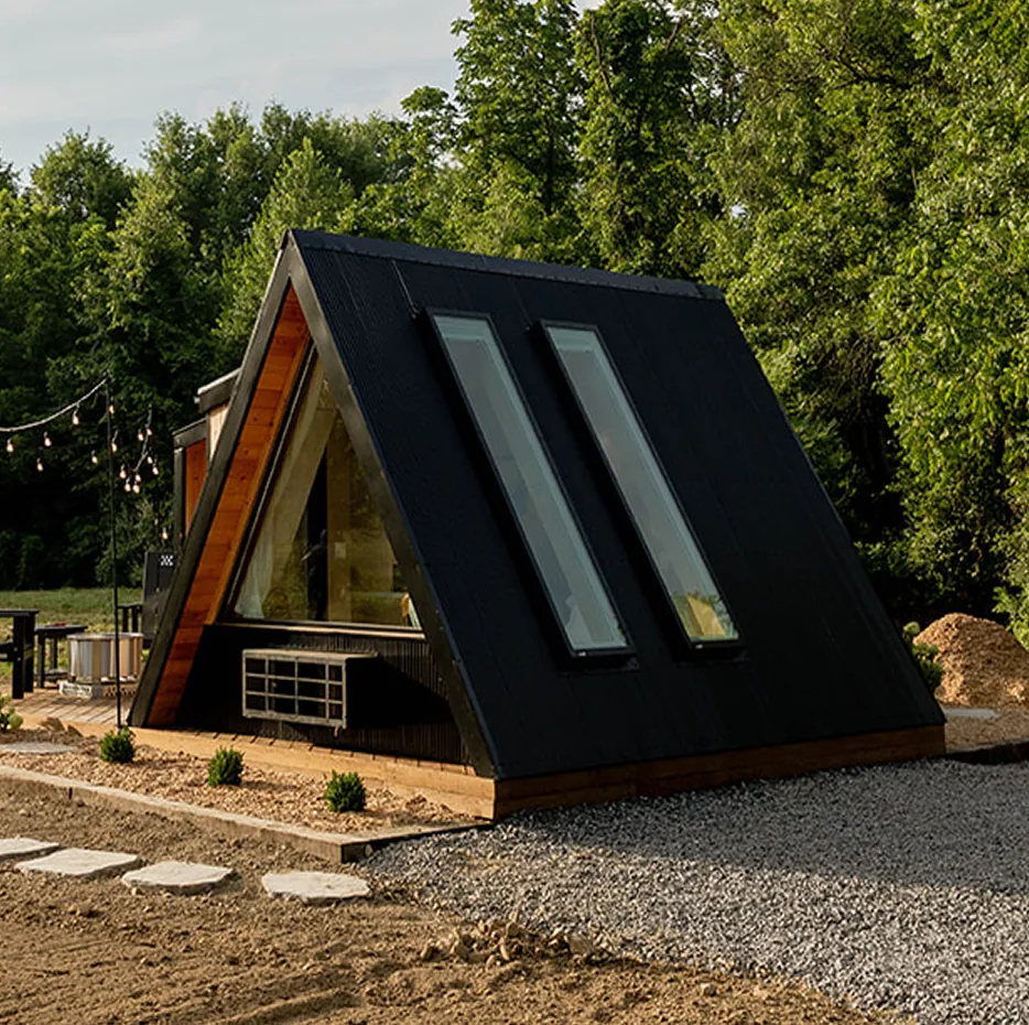 The Wanderhut model A-frame cabin with two skylights, set in a wooded area.