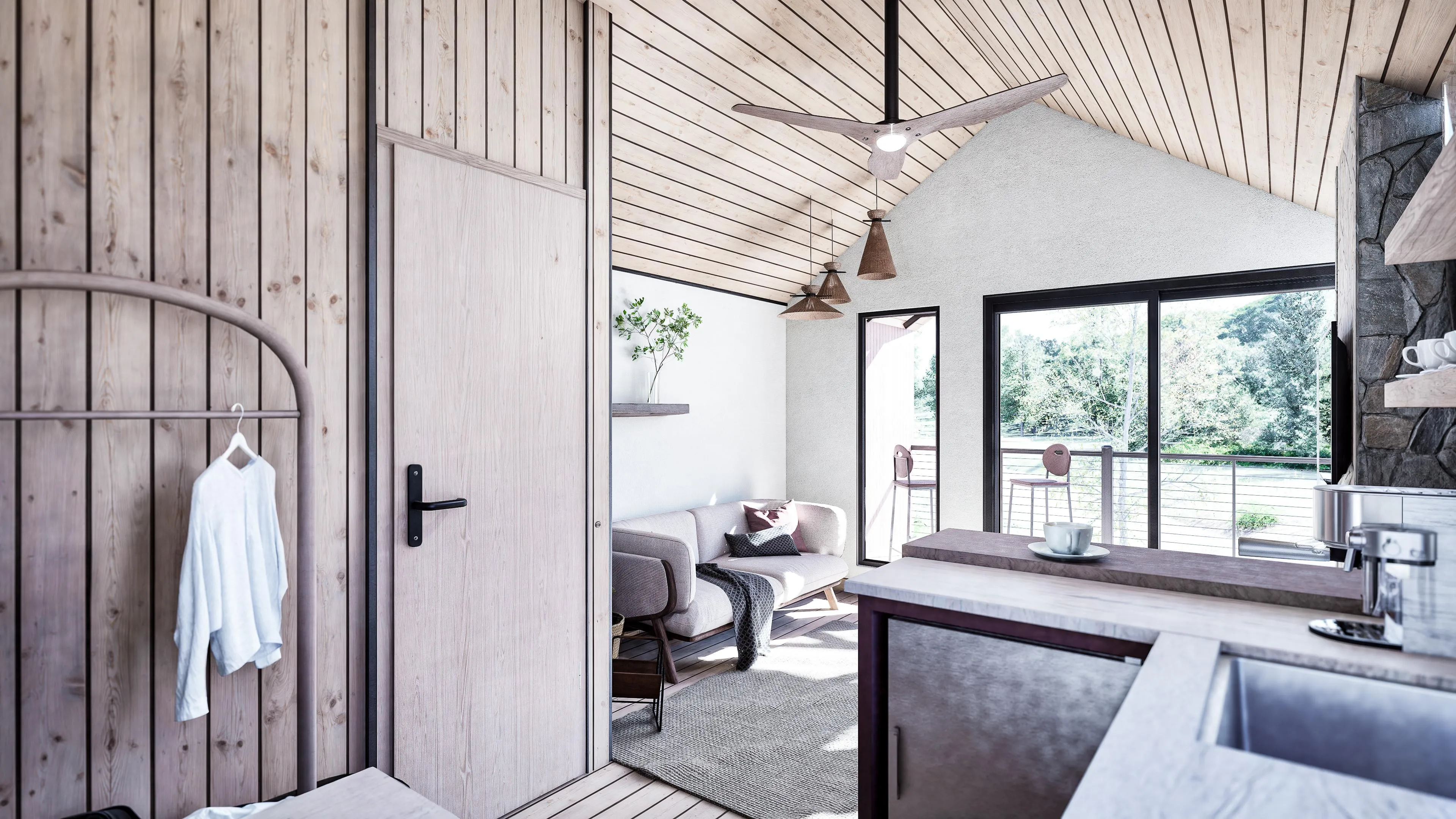 Bright, modern cabin interior with wood paneling, a small sitting area, large windows, and a view of greenery outside.