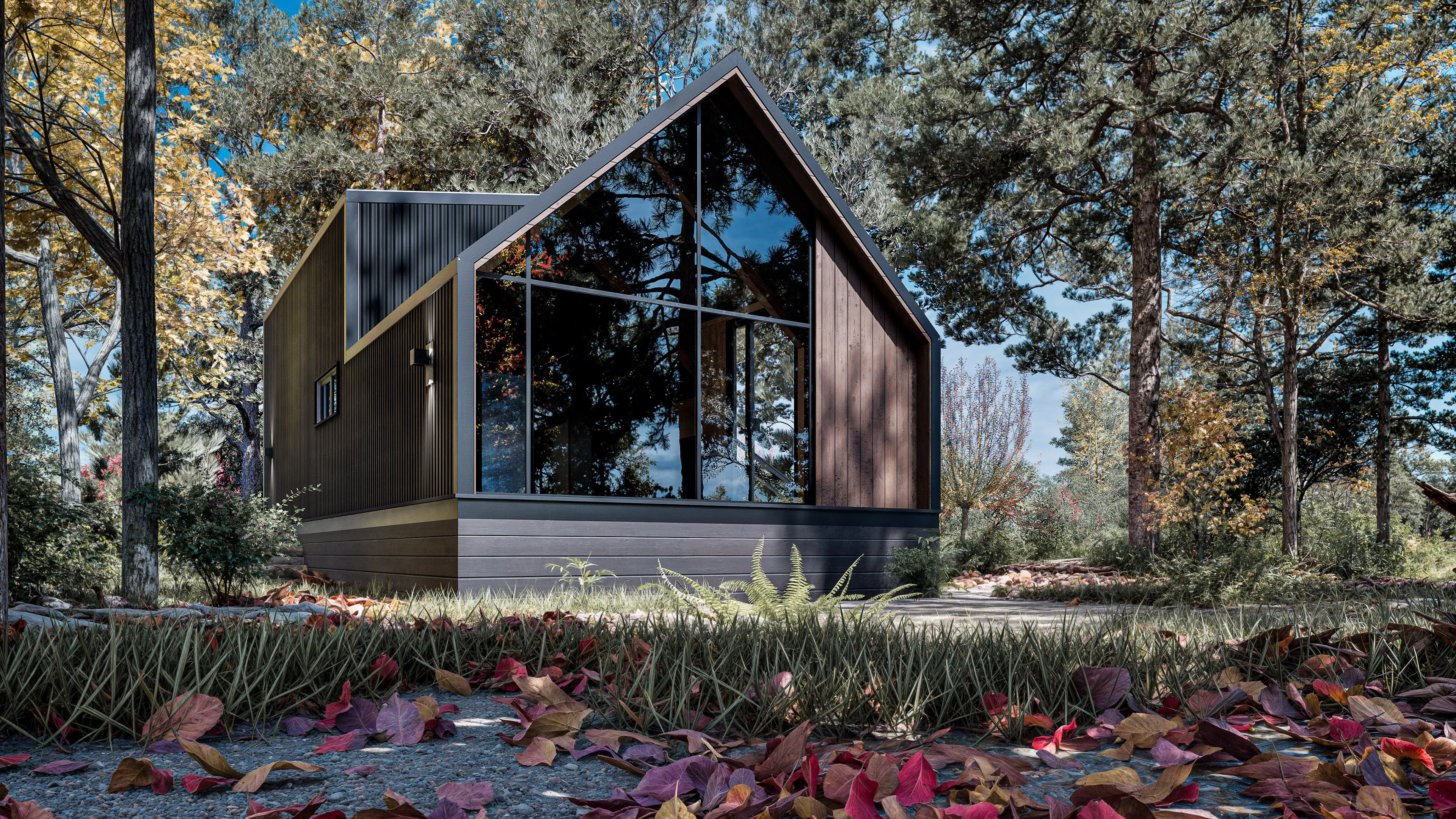 A modern cabin with large glass windows sits among trees in an autumn forest, with fallen leaves covering the ground in the foreground.