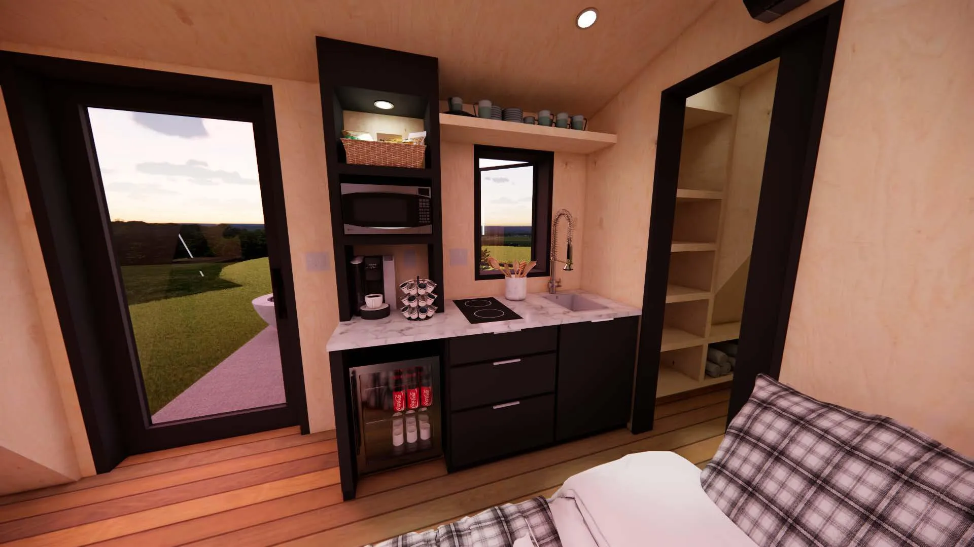 Compact kitchen area with a sink, stovetop, microwave, shelves with dishes, and a mini fridge; adjacent to a bed and open closet, with doors leading outside.