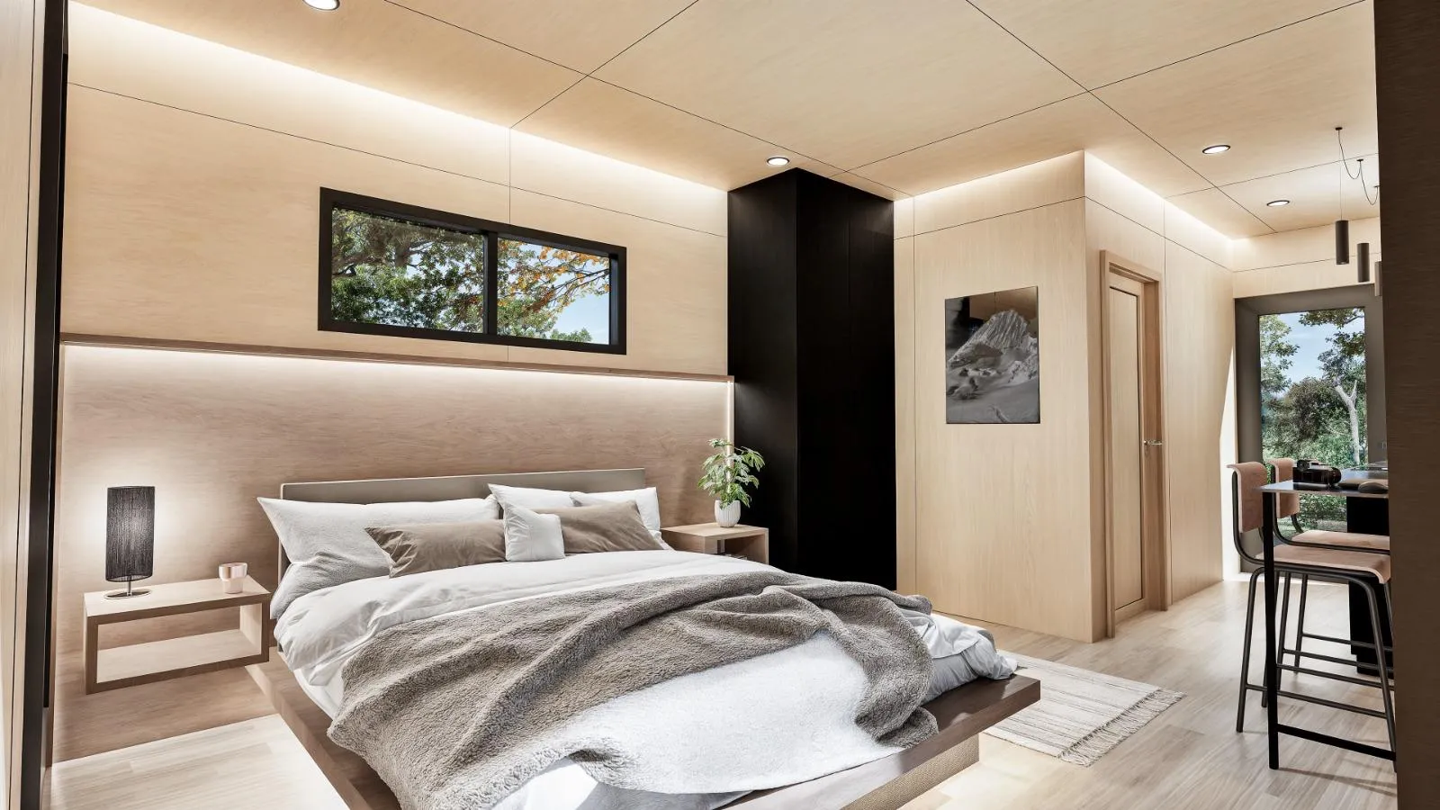 Modern bedroom inside the Vista Cabin with wood-paneled walls and ceiling, a large bed, bedside tables, a window, a black accent wall, and a small dining area with high chairs.